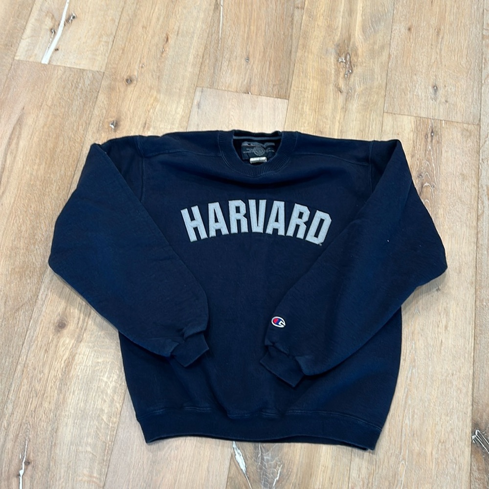 Small navy blue Harvard Champion crew neck sweat shirt.
